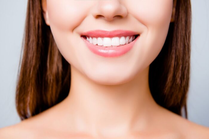Concept of healthy wide beautiful smile. Cropped close up photo of healthy smile, isolated on grey background teeth whitening cosmetic dentistry dentist in Bala Cynwyd Pennsylvania